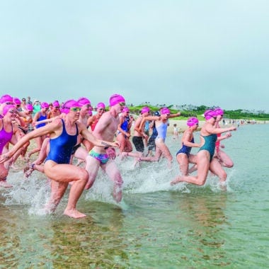Swim Across America Nantucket swimmers running into ocean