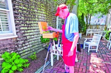 Artist displaying original artwork during an Artists Association of Nantucket Patio Pop-Up