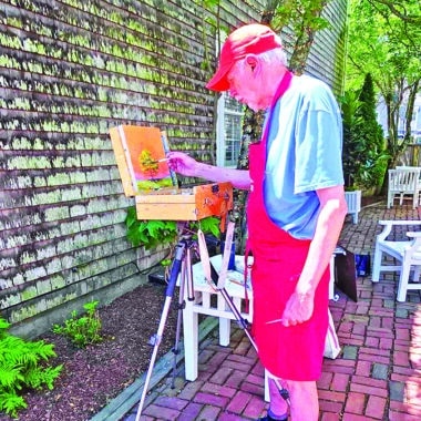 Artist displaying original artwork during an Artists Association of Nantucket Patio Pop-Up