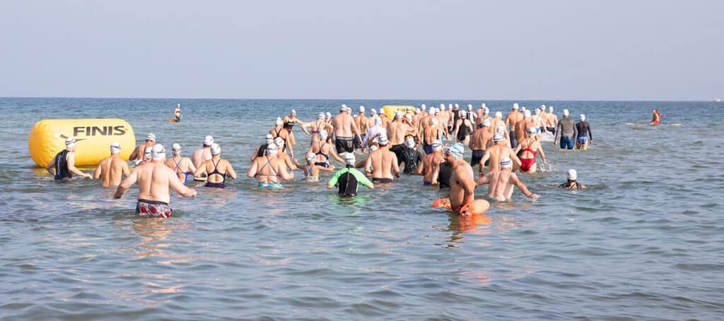 Swimmers at Jetties Beach participate in the Swim Across America Nantucket charity open water swim raising funds for cancer care and research.