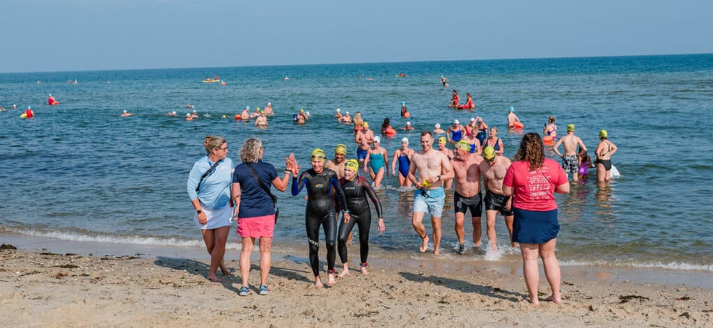 Swimmers at Jetties Beach participate in the Swim Across America Nantucket charity open water swim raising funds for cancer care and research.