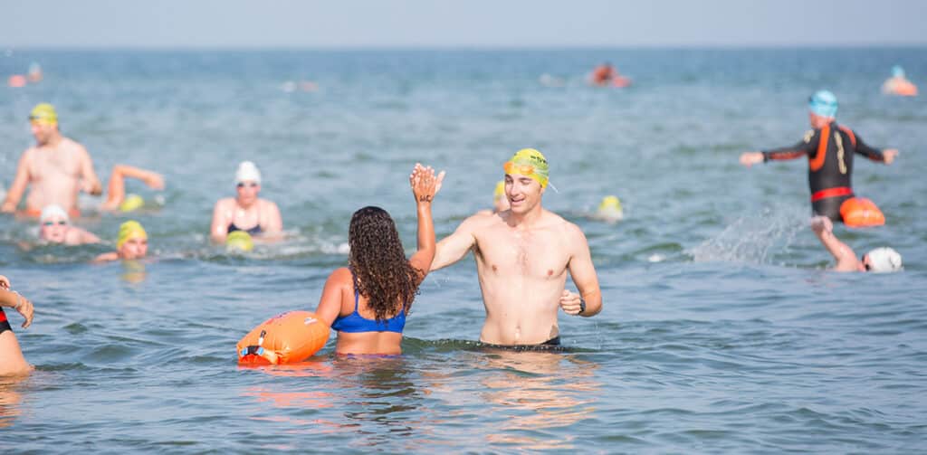 Swimmers at Jetties Beach participate in the Swim Across America Nantucket charity open water swim raising funds for cancer care and research.