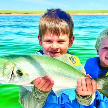 Two young anglers proudly hold up a bluefish caught during the August Blues Nantucket Fishing Tournament.