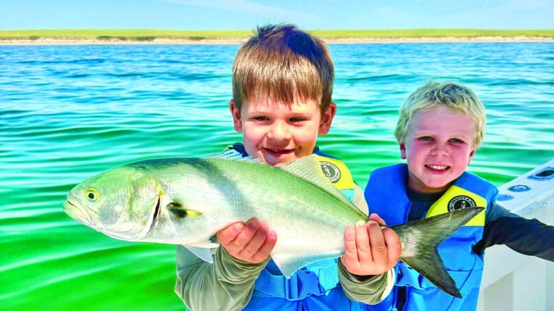 Two young anglers proudly hold up a bluefish caught during the August Blues Nantucket Fishing Tournament.