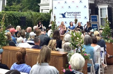 A Nantucket Film Festival panel discussion draws a crowd at an outdoor venue during festival programming.