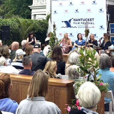 A Nantucket Film Festival panel discussion draws a crowd at an outdoor venue during festival programming.