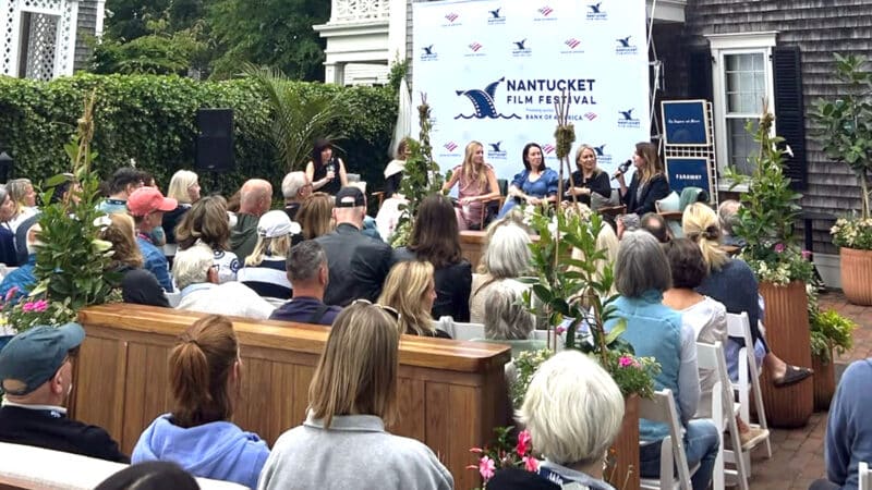 A Nantucket Film Festival panel discussion draws a crowd at an outdoor venue during festival programming.