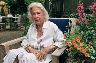 Nantucket jeweler Susan Lister Locke sits in her garden wearing gold bracelets and rings from her own collection.