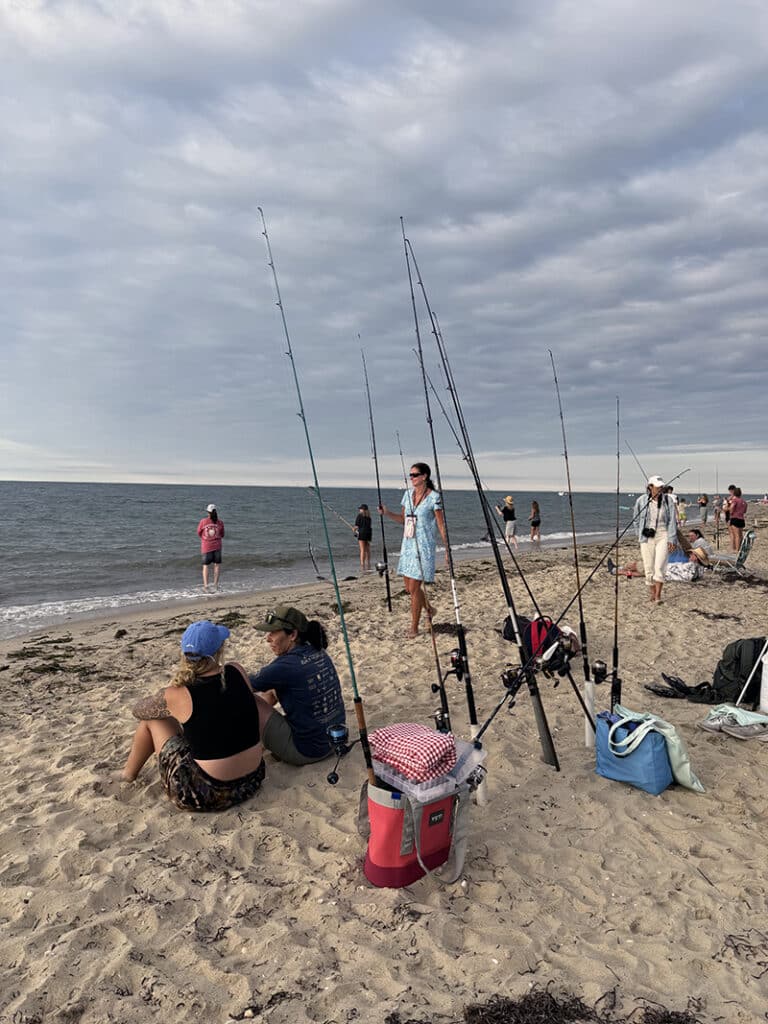 Participants gather with their gear on the beach at Tammy King's women's fishing seminar on Nantucket.